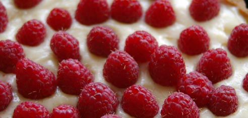 naked raspberries on top of tart