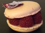 fancy large macaron with raspberries and rose petal